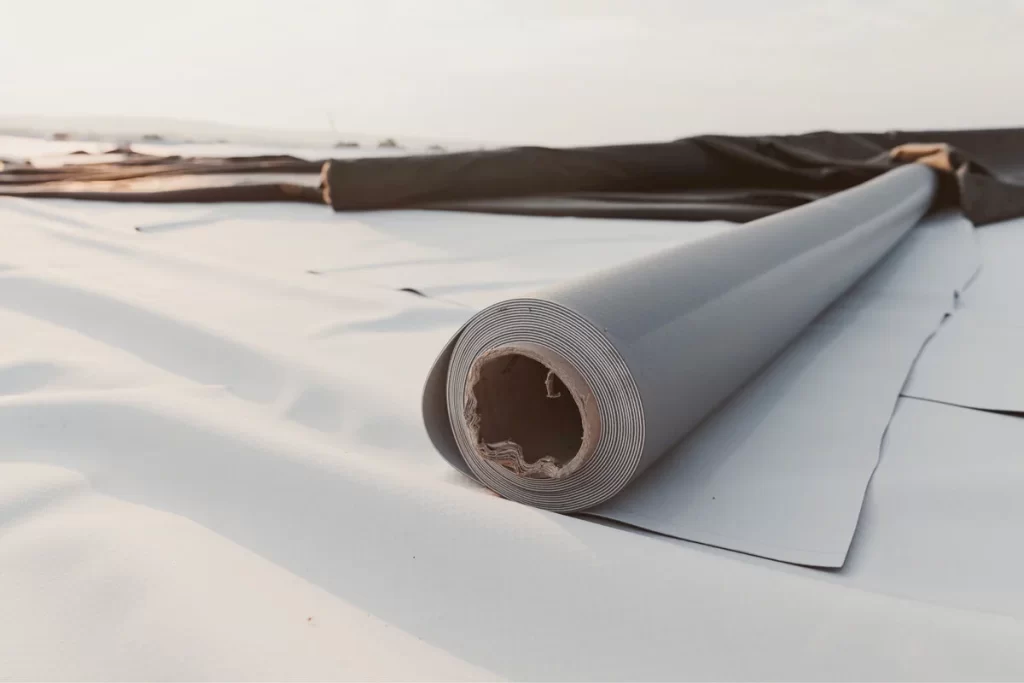 grey-white UV resistant rubber membrane roll laying on a roof